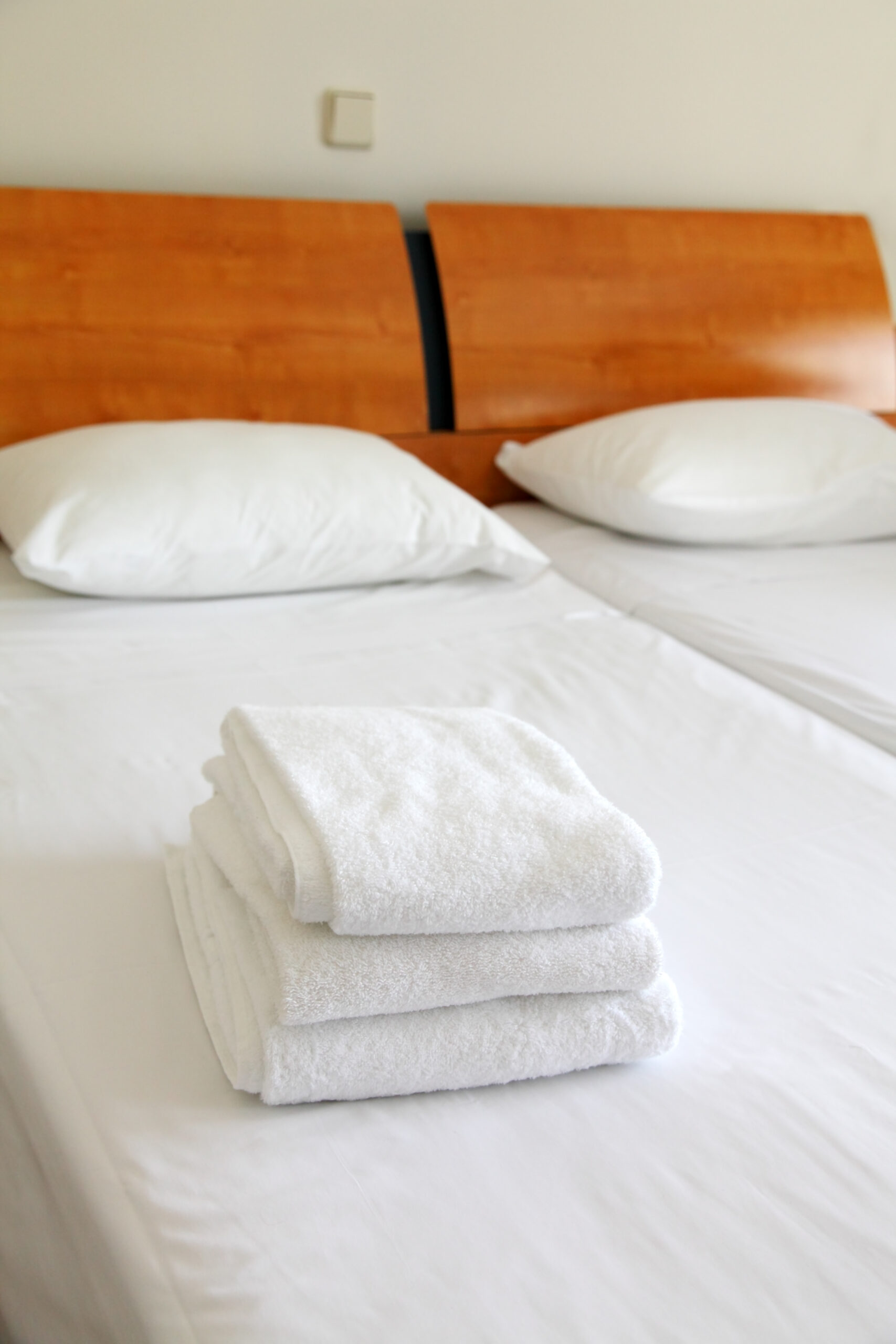Three towels on the beds in the hotel
