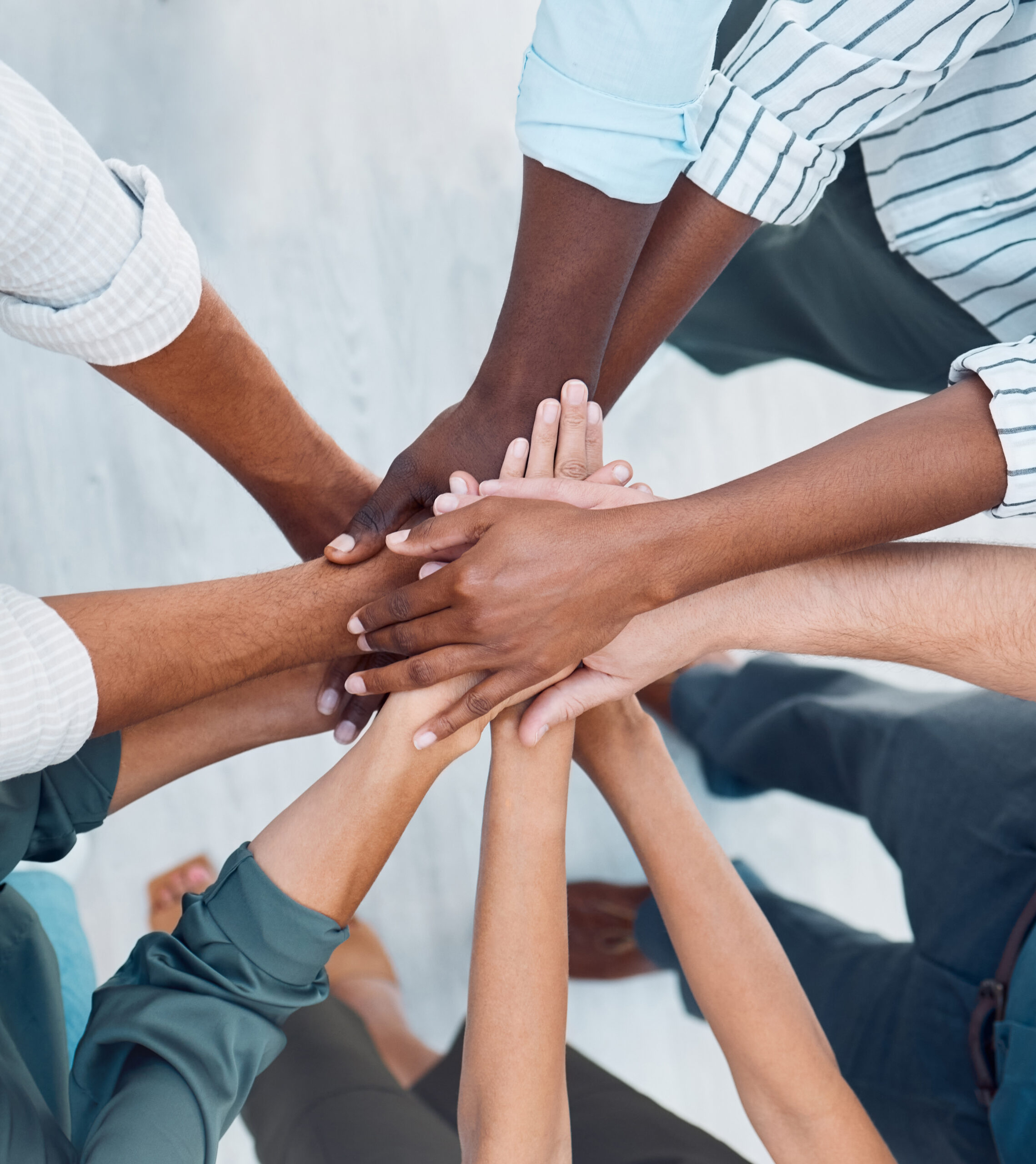 Diversity, hands and team above in support.